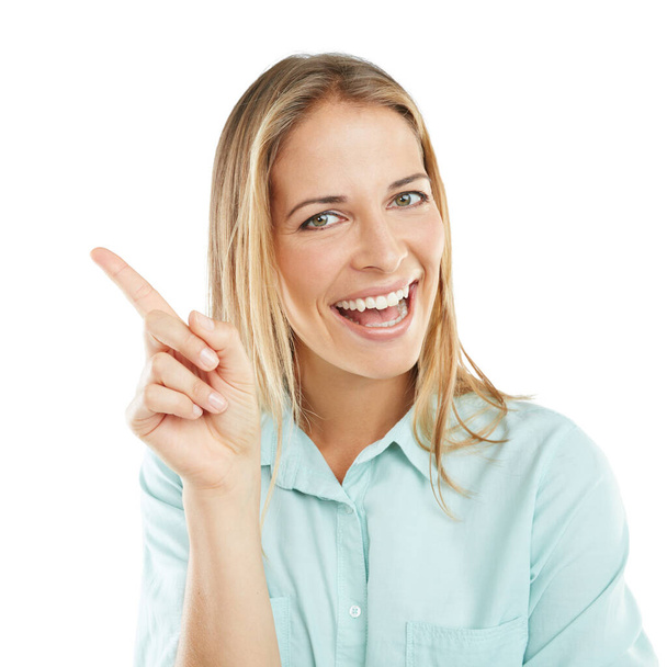 Olha para isto. uma mulher feliz apontando para espaço em branco copyspace em um fundo branco - Foto, Imagem