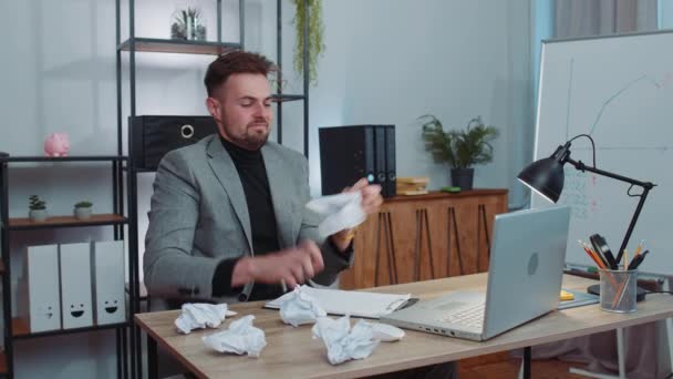 Angry furious man working at home office throwing crumpled paper, having nervous breakdown at work, migaine, headache, stress management, mental distress problems, losing temper, reaction on failure - Footage, Video