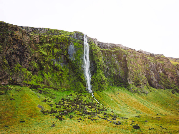 Iceland waterfall nature travel landscape in Icelandic nature background. Popular tourist attraction summer holiday destination in on South Iceland. High quality photo - Foto, imagen