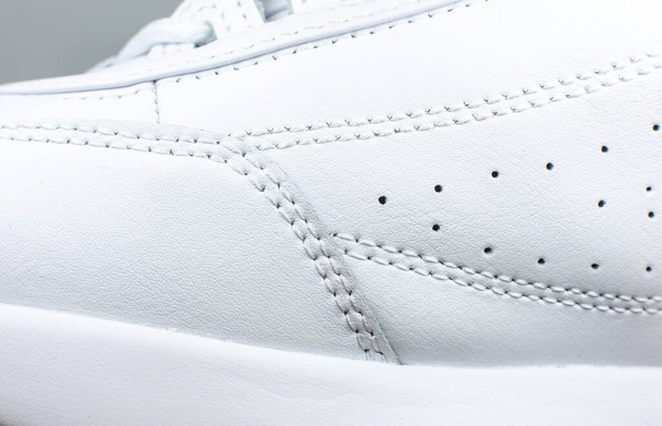 Modern sneakers  background. White leather trainers. Seams Close up. Natural fabrics, textile material. - Fotoğraf, Görsel