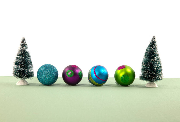 Modern Christmas tree decor and christmas baubles on a grain floor against a whitebackground with copy space - 写真・画像