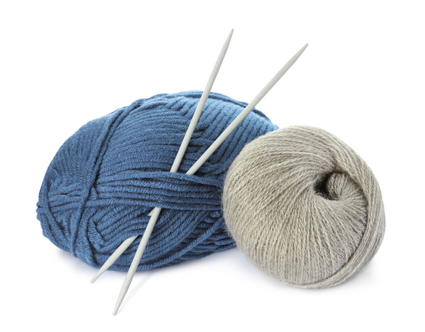 Different balls of woolen knitting yarns and needles on white background - Foto, imagen