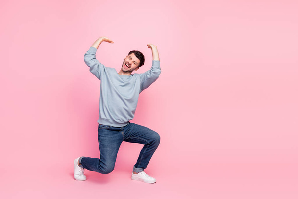 Full size photo of handsome young man lifting up heavy copyspace feel pressure wear stylish blue garment isolated on pink color background. - Φωτογραφία, εικόνα