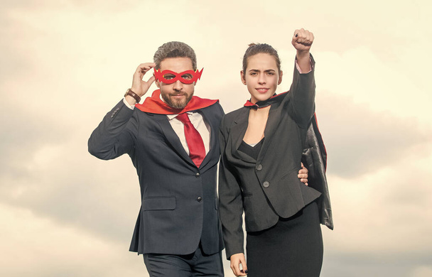 business colleagues in superhero suit on sky background. - Фото, изображение