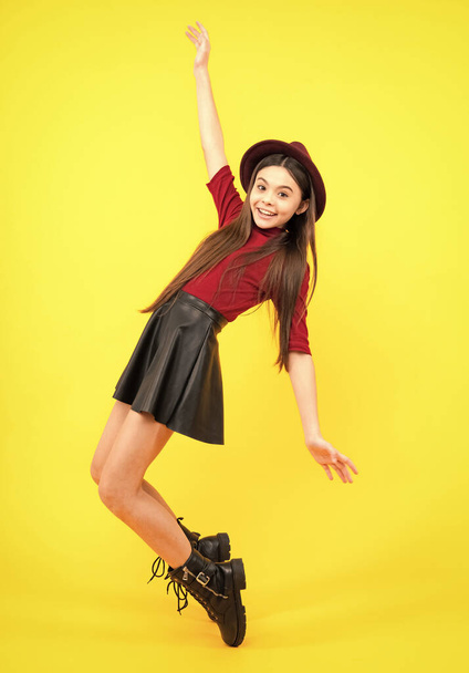 Full size walk on isolated studio wear hat, casual wear, fashion skirt and shoes. Happy teenager portrait. Smiling girl - 写真・画像