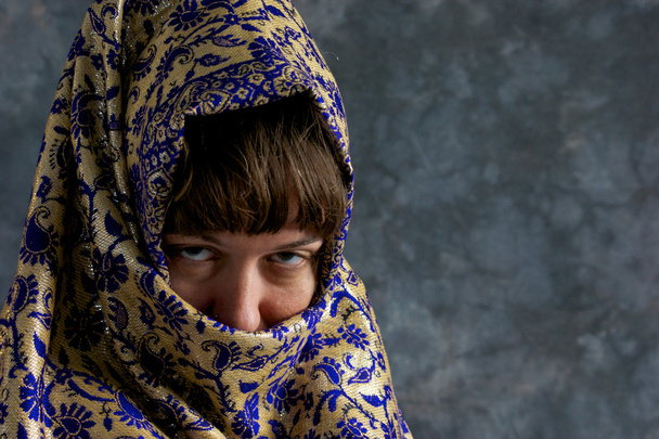 Woman with face wrapped in exotic shawl - Photo, Image