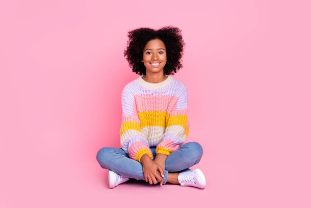 Full size photo of funny satisfied girl with perming coiffure dressed knit pullover sitting legs crossed isolated on pink color background. - Foto, immagini