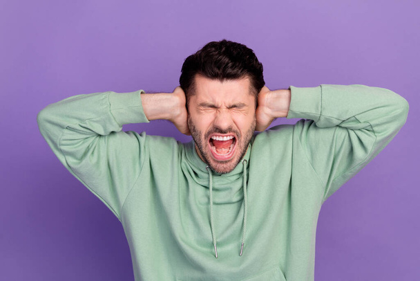 Closeup photo of agressive young businessman hate his life close ears loud social sounds problems depressed scream isolated on violet color background. - Photo, Image