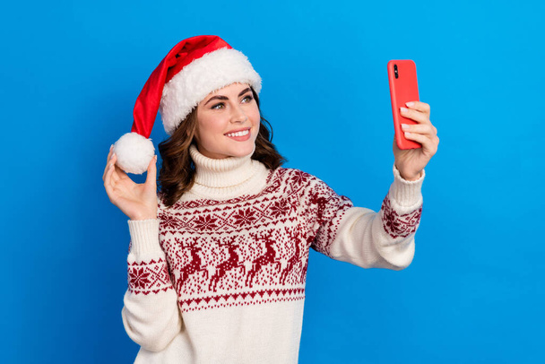 Photo of charming pretty lady wear ugly print pullover chatting webcamera call talk make selfie picture isolated on blue color background. - Zdjęcie, obraz