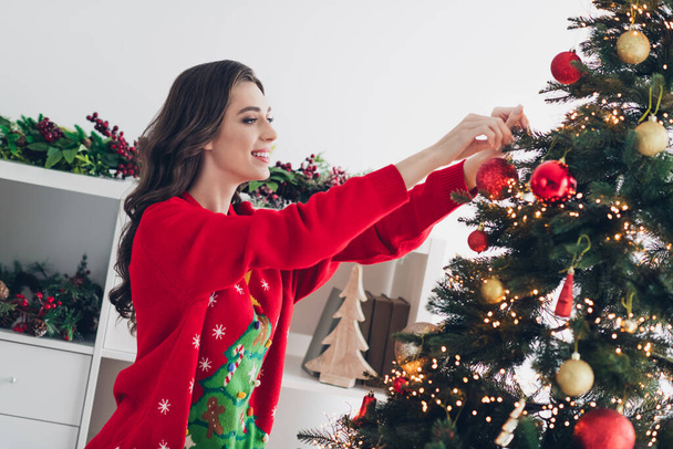 Photo of attractive positive lady decorating pine tree home house room indoors listening new year music enjoy best time season. - Fotoğraf, Görsel