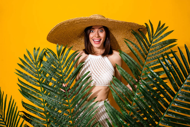 Photo of sweet excited girl dressed knitted bra straw cap enjoying jungle trip isolated yellow color background. - Фото, зображення