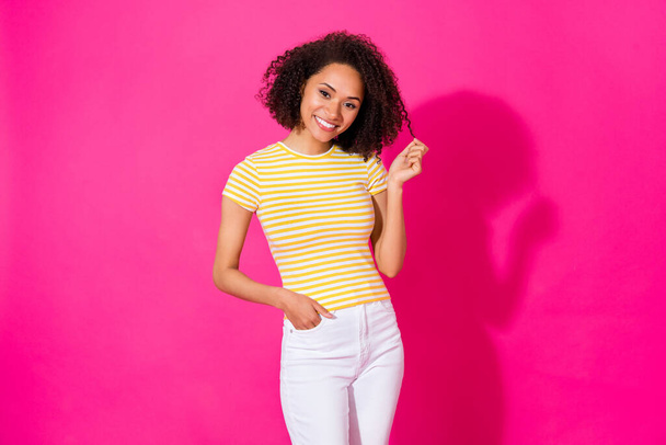 Portrait photo of young adorable gorgeous girl touch curls toothy smile hand pocket girlfriend isolated on pink color background. - Foto, afbeelding