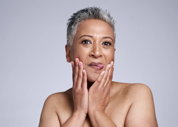 Skincare, comic and senior model with beauty, cosmetic and natural face routine in studio. Goofy, wellness and portrait of elderly lady with tongue out with healthy skin isolated by gray background - Foto, afbeelding