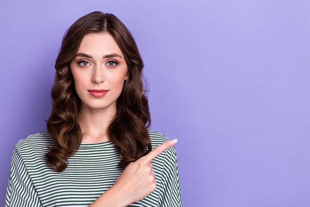 Closeup portrait of charming confident curly hairstyle directing finger empty space new salon opening isolated on pastel violet color background. - Fotó, kép