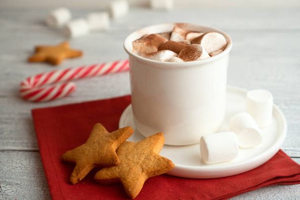 Shaped ginger cookies with hot cocoa. Traditional sweet New Year's drink with spicy cakes to treat Santa Claus and children - Foto, Bild