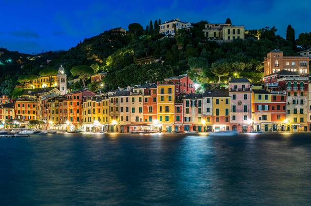 View of the old town of Portofino, illuminated at dusk, world famous ancient maritime village in the Italian Riviera - Photo, Image