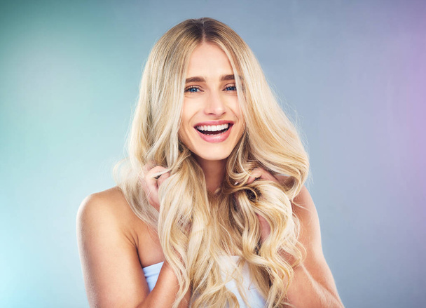 Beauty, hair and face with a model woman in studio on a neon background for wellness or treatment. Portrait, salon and hairstyle with an attractive young female posing to promote natural haircare. - Φωτογραφία, εικόνα