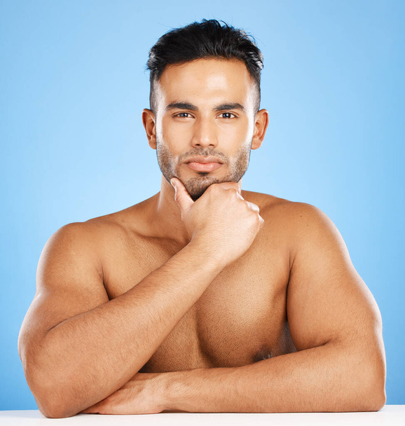 Portrait, muscular man and health for wellness, skincare and hygiene with blue studio background. Athlete male, bodybuilder and happy for body care, workout and content with motivation and fitness - Zdjęcie, obraz