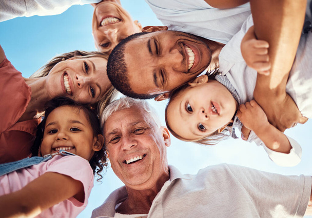 Diversity, huddle and family with smile, happy and bonding together for vacation, spend quality time and joyful. Interracial, grandparents or parents with kids being cheerful, happiness and low angle. - 写真・画像