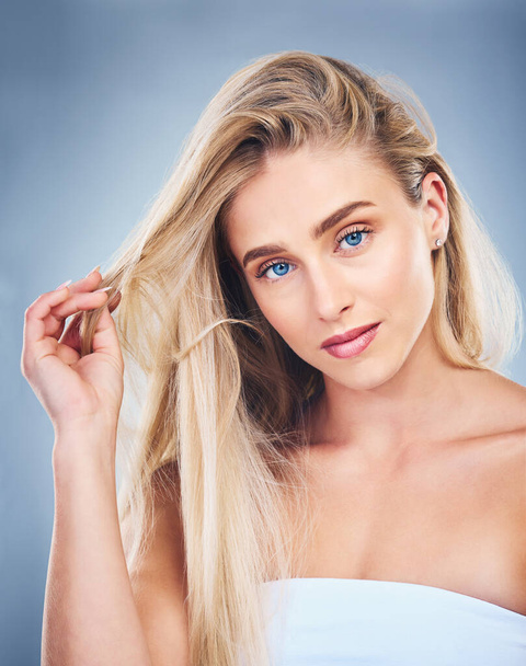 Salon, hair and woman on with care for hairstyle and strength on a grey studio background. Haircare, hair style and beauty woman with healthy blonde hair for glamour and cosmetic treatment. - 写真・画像