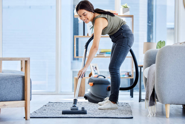 Smile, vacuum machine and woman cleaning the floor in the living room in home. Happy latino cleaner doing housework, housekeeper or job in a clean lounge, hotel room or house while spring cleaning. - Fotoğraf, Görsel