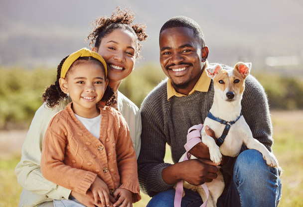Happy family, dog and portrait and a park, relax and smile while bonding in nature, calm and cheerful. Happy, black family and love with girl, pet and parents enjoying quality time in a forest. - Photo, image