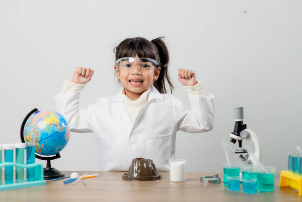 education, science, chemistry and children concept - kids or students with test tube making experiment at school laboratory - 写真・画像