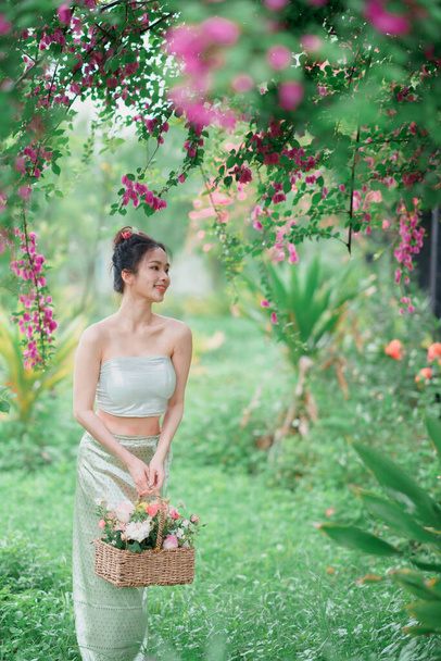Dziewczyna w tradycyjnej chińskiej sukience jest w ogrodzie - Zdjęcie, obraz