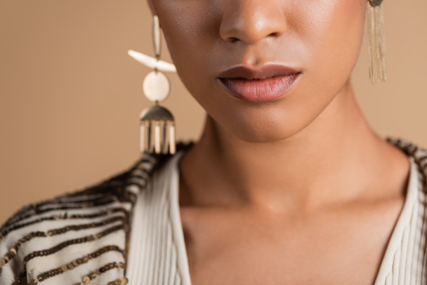 cropped view of african american woman in golden earrings posing isolated on beige  - Fotoğraf, Görsel