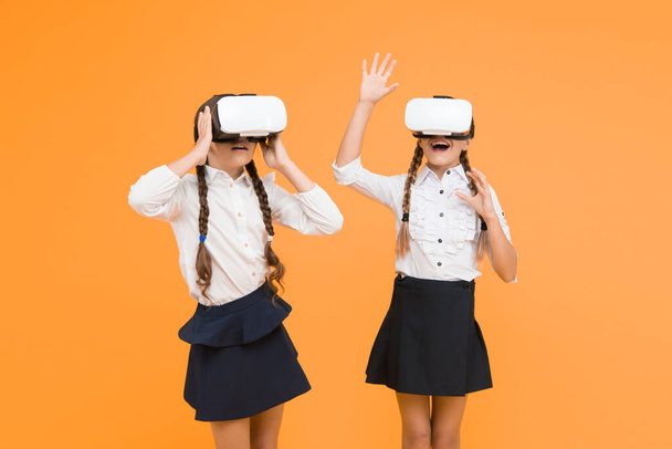 Enjoy new experience. Happy kids use modern technology. future education. back to school. Digital future and innovation. virtual reality. small girls in VR headset. children wear wireless VR glasses. - Foto, Imagen