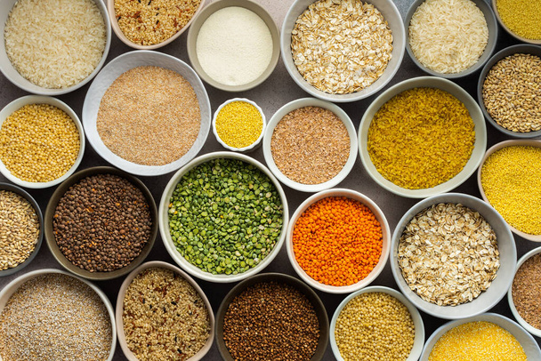 Various grain cereals in bowls on a light background, top view - Photo, Image