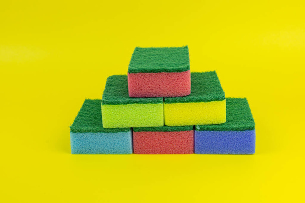 heap of Color sponges dish washing isolated on colorful background - Photo, Image