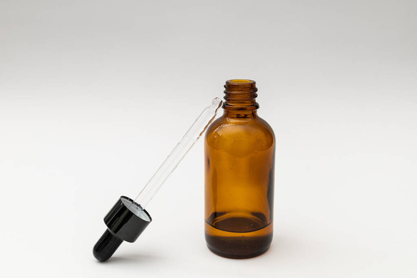 Glass jar with pipette filled with liquid - Photo, Image