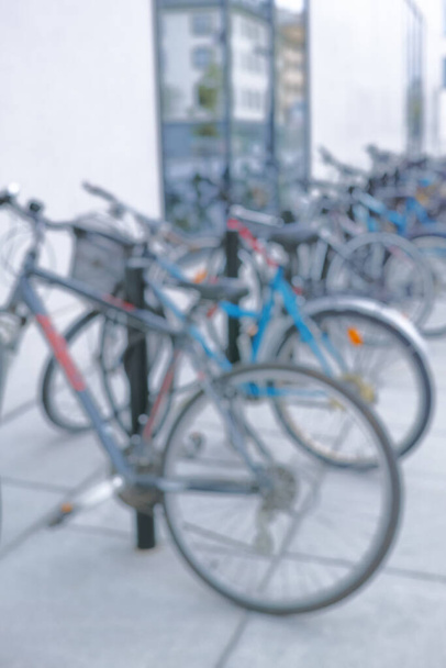 Ready to ride. Blurred shot of a bicycles at a bicycle rack in a city - Fotó, kép
