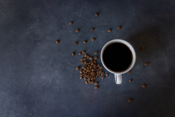 Фото сверху чашки фильтрующего кофе, кофейных зерен на темном фоне, концепции кофе, избирательного фокуса, копировального пространства - Фото, изображение