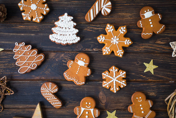 Christmas cookies of various shapes with sugar decor glaze on the wooden table, flat lay with decor - Valokuva, kuva