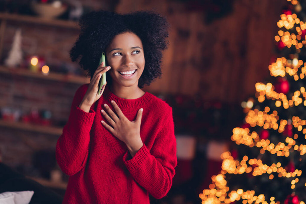 Portrait of funny positive schoolkid speak communicate telephone congratulate winter newyear spirit indoors. - Фото, изображение
