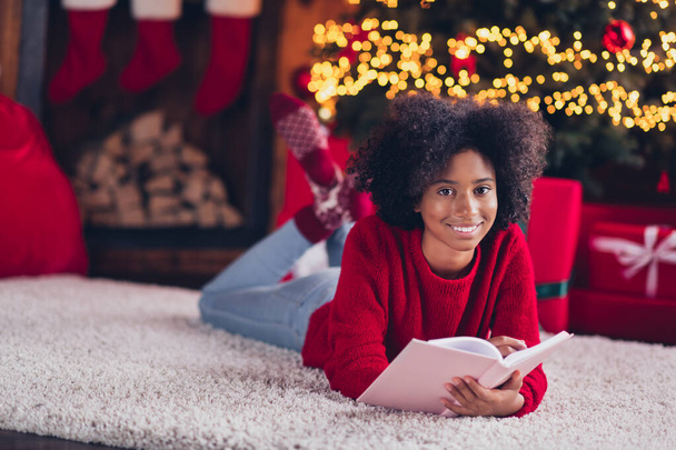 Photo of glad lovely pretty lady child teenager wear red jumper lying fluffy carpet floor indoors cozy room rest write letter santa claus . - Foto, afbeelding