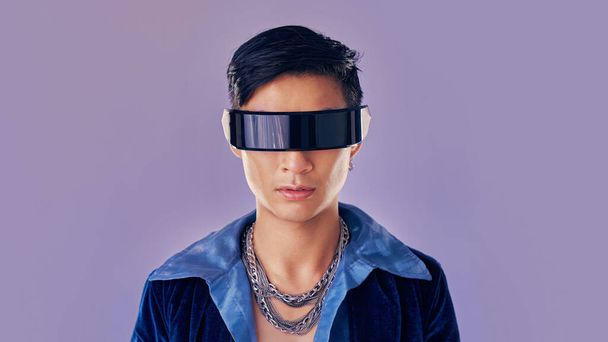 Face, cyberpunk and virtual reality with asian man in futuristic eyewear in studio on purple background for metaverse or 3d fashion. Portrait, robot and future of young male in glasses for fantasy ai. - Photo, image