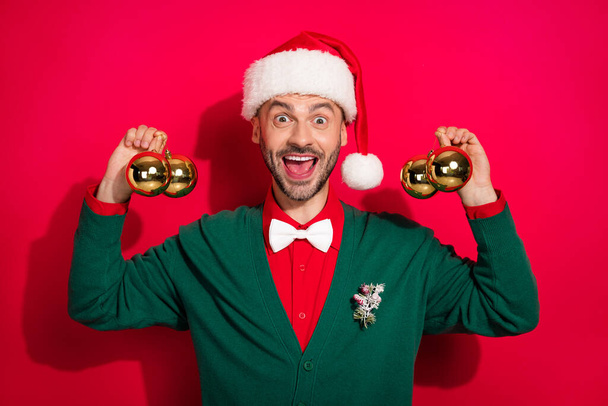 Photo of sweet impressed guy dressed xmas green cardigan bowtie ready decorate christmas tree isolated red color background. - Φωτογραφία, εικόνα
