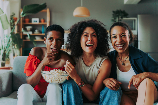 Happy beautiful hispanic south american and black women meeting indoors and having fun - Black adult females best friends spending time together, concepts about domestic life, leisure, friendship and togetherness - Foto, immagini