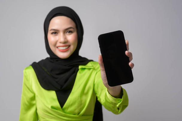 A Beautiful musllim woman with hijab using smartphone over white background, technology concept. 		 - Fotografie, Obrázek
