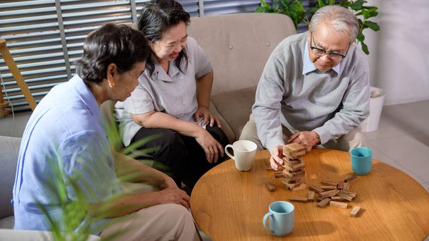 Group of elderly people enjoy talking , relaxing with game at  senior healthcare center. - Foto, Imagem