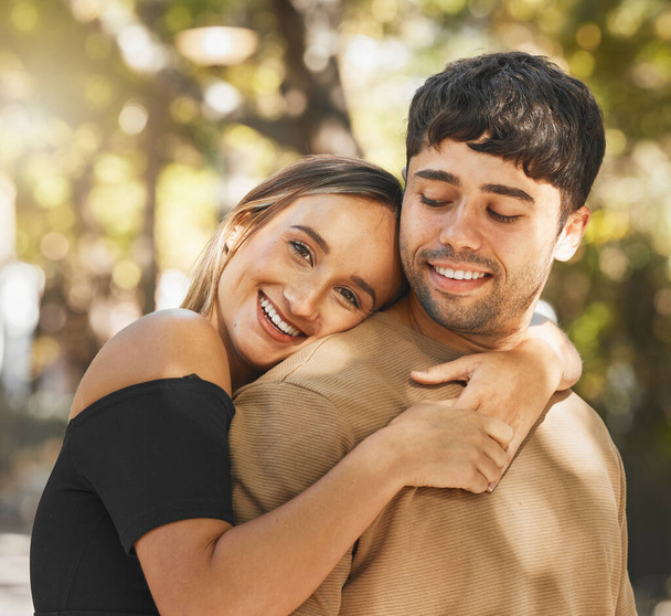 Love, couple and hug being happy, smile and romantic for relationship, bonding and outdoor together. Romance, man and woman embrace, being loving and connect for happiness, passion and content - Фото, изображение