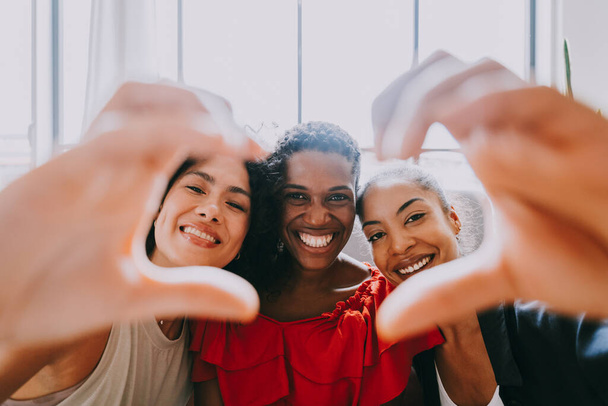 Happy beautiful hispanic south american and black women meeting indoors and having fun - Black adult females best friends spending time together, concepts about domestic life, leisure, friendship and togetherness - Photo, Image