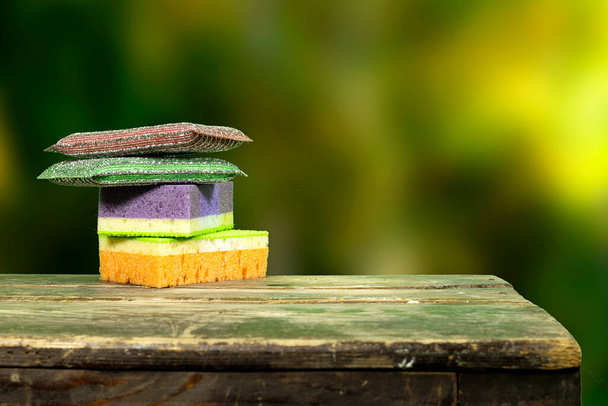 different sponge cleaning on  wooden board over nature blur grass, park background - Photo, image