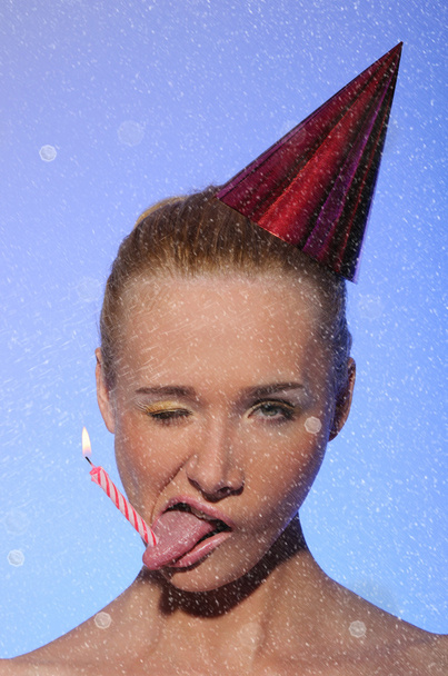 Woman with cap on his head, candle, snow - Φωτογραφία, εικόνα