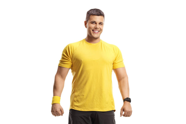 Young man in a yellow sports top smiling at camera isolated on white background - Foto, afbeelding