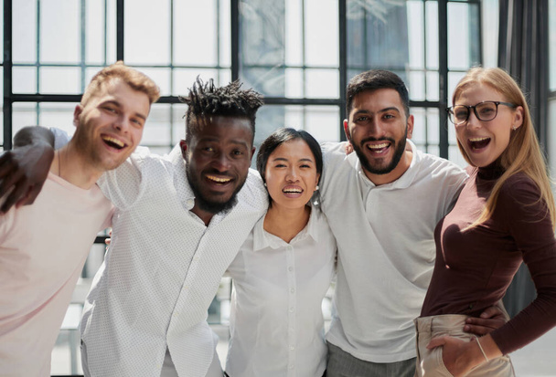 Portrait of successful creative business team looking at camera and smiling. Diverse business people standing together at startup. - Foto, imagen