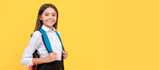 smiling teen girl in school uniform carry backpack, knowledge day. Portrait of schoolgirl student, studio banner header. School child face, copyspace - Photo, image